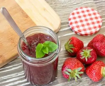 homemade strawberry jam in a jar with a gift tag